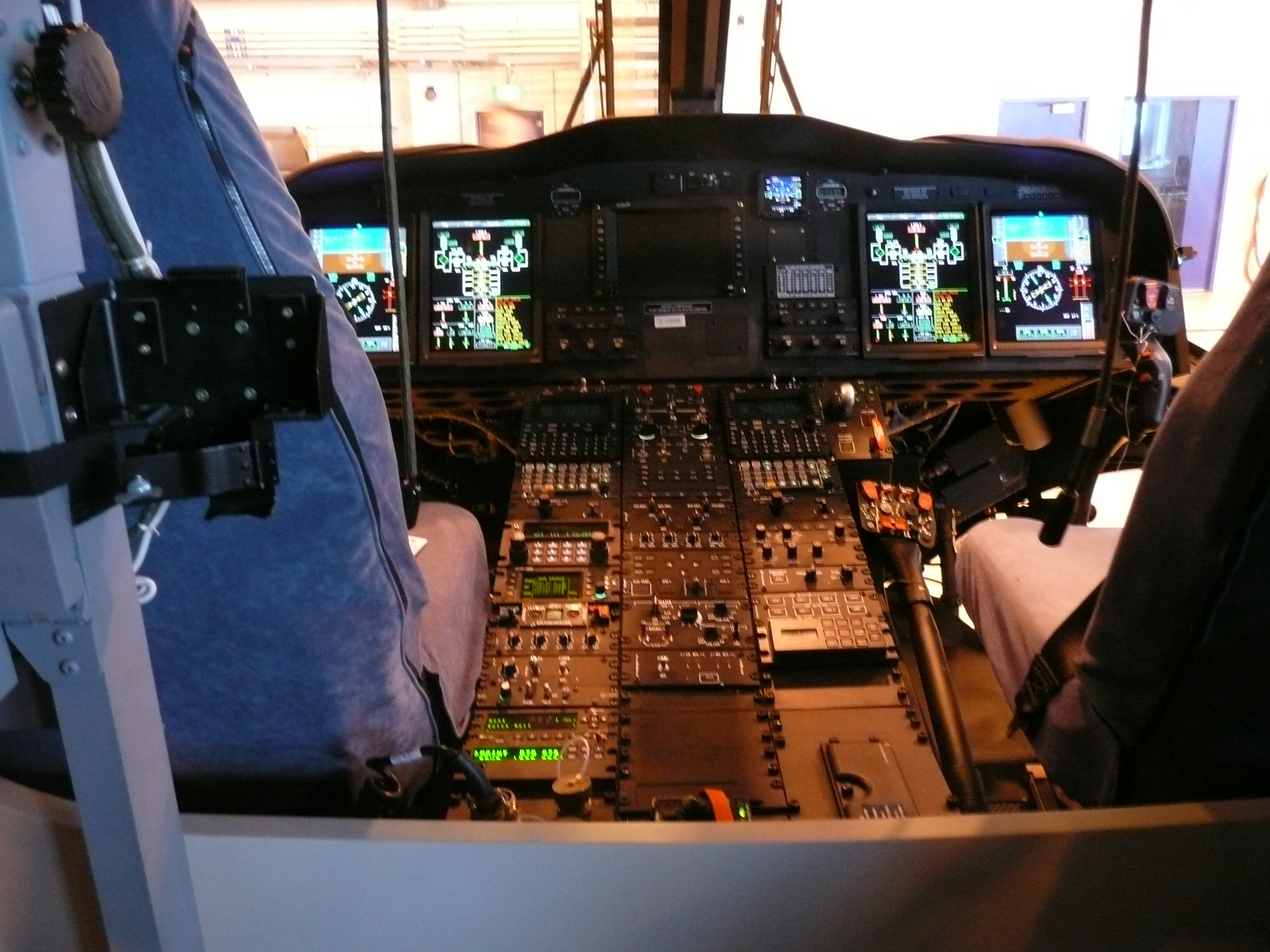 AW139 helicopter cockpit with multiple flat-panel flight and systems displays.